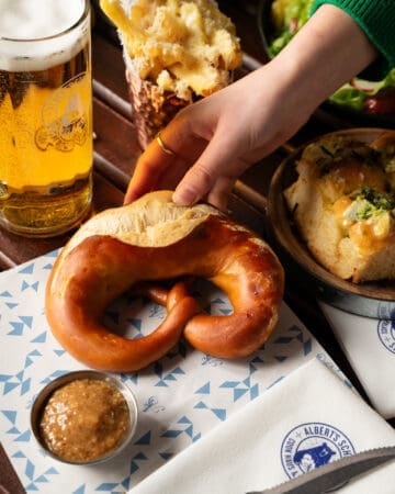 freshly baked pretzel with homemade dipping sauces